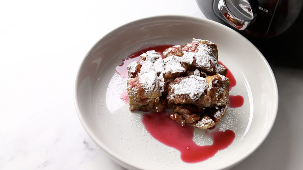 Vegan Slow Cooker French Toast plated with raspberry sauce